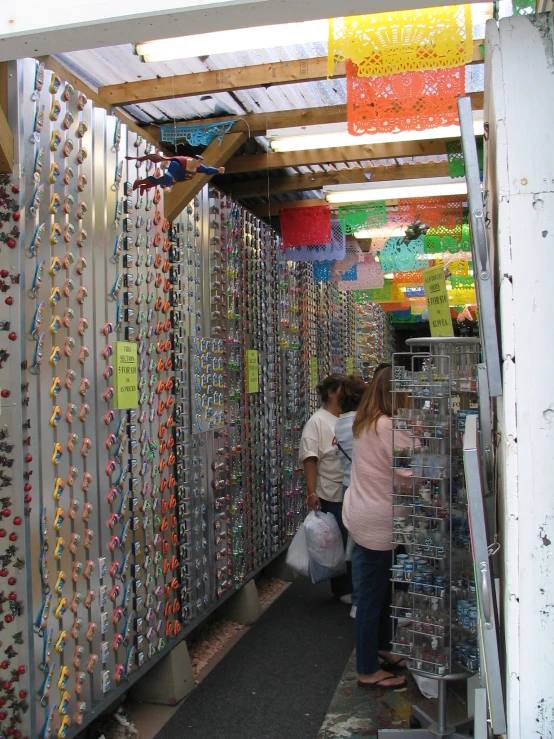 a store with colorful necklaces and people