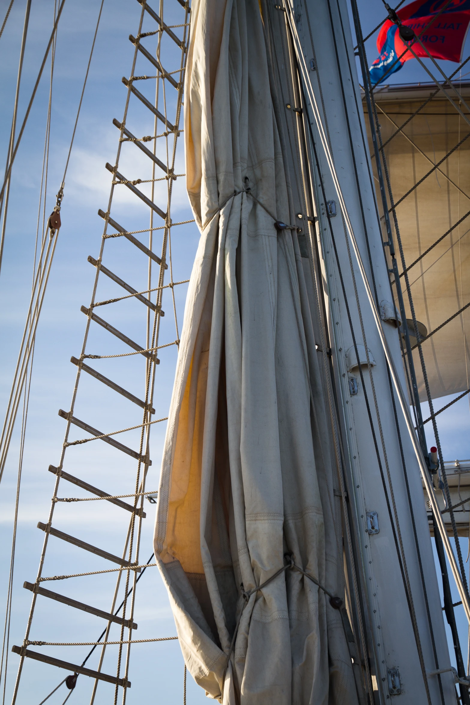 an up close image of some ropes and the sails