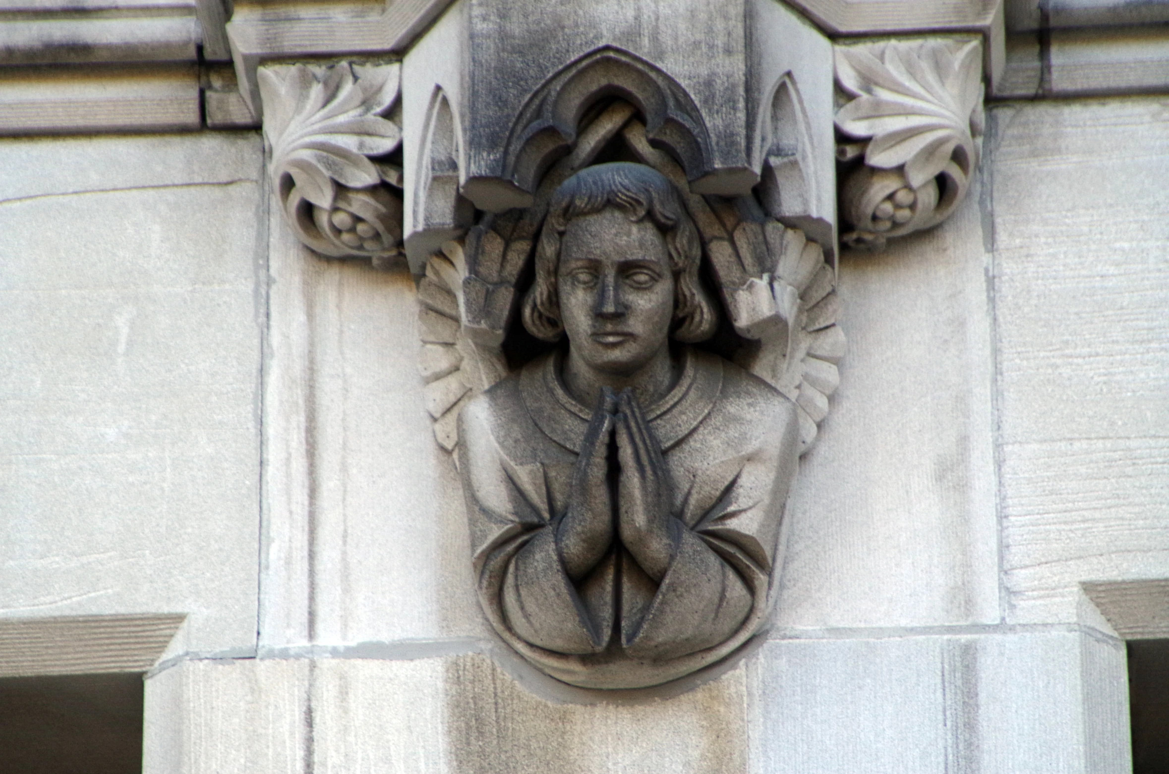 a sculpture with a woman's head sitting on a ledge