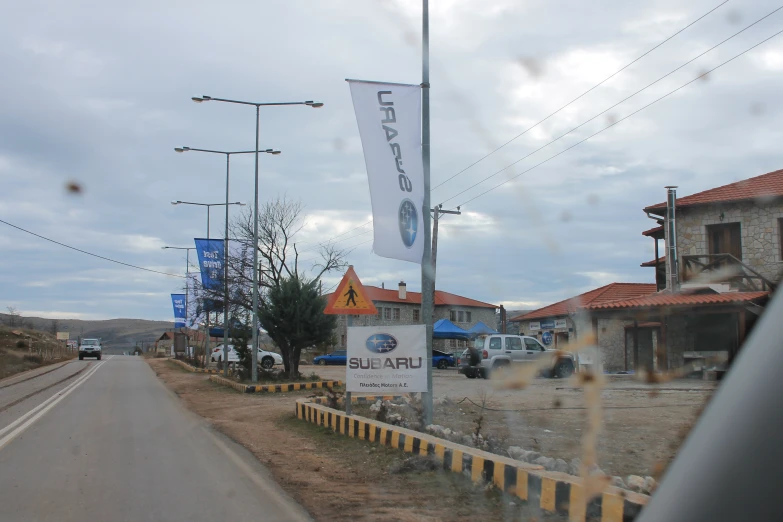 a sign on the side of a road in front of a building