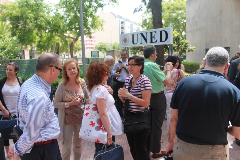 many people are gathered outside of a building for the united