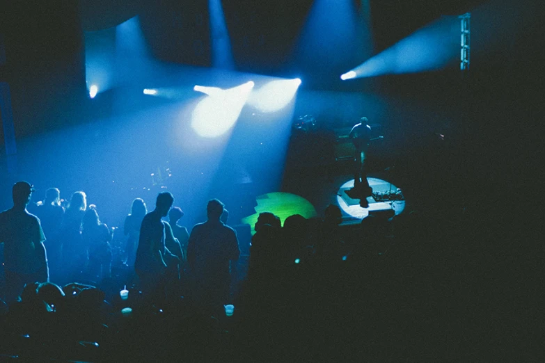 a dark room with spotlights from the front and behind on a band