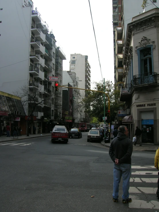 an intersection at a cross walk is lined with buildings