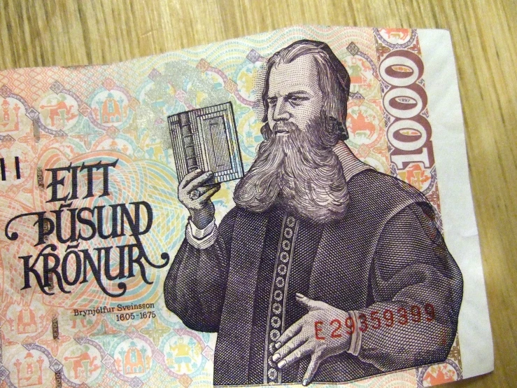 a paper money with a man in front of it