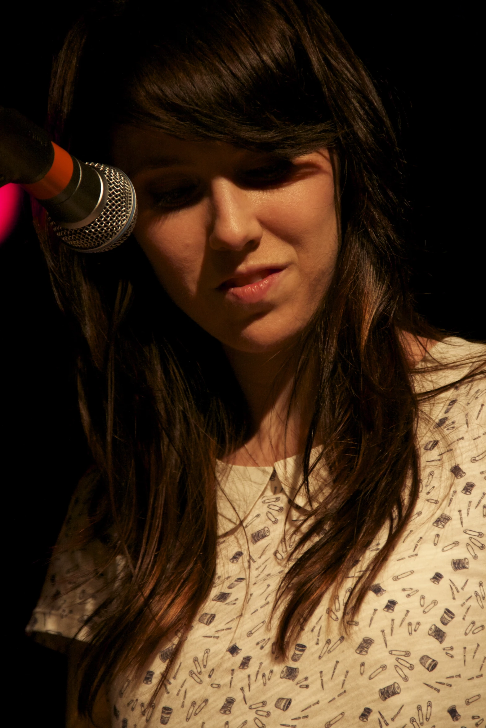 girl playing with a microphone in the dark