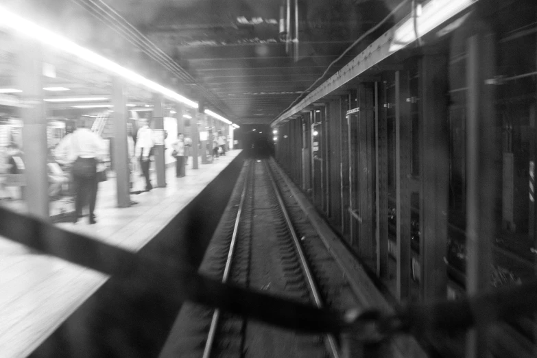 black and white po of people on the train tracks