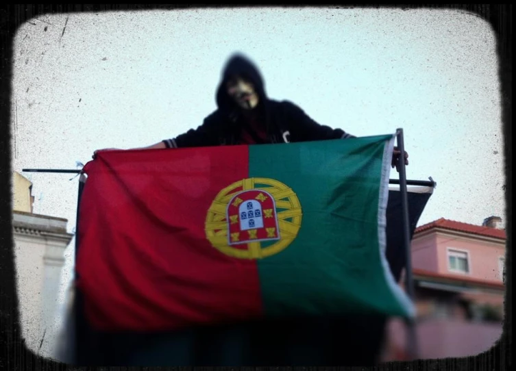 a man in black is holding a colorful flag