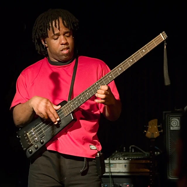 a man is playing an electric guitar on stage