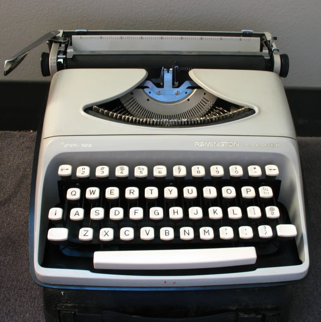 the typewriter is silver with an antique keyboard