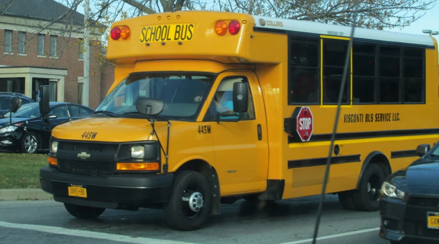 a yellow school bus parked in front of a building