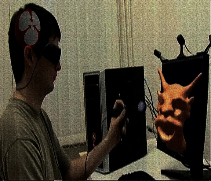 a man in front of a computer screen with a clock on it