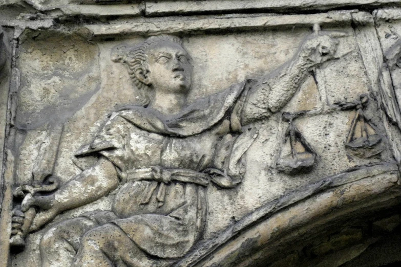 a relief of a statue sitting on top of a cement slab