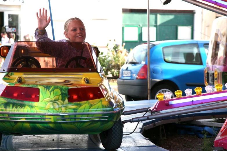 a small child is driving in a bumper car