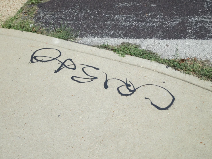 there is graffiti on the sidewalk of a street corner