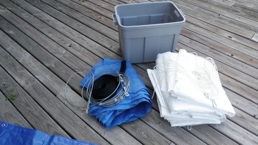 some bags and a basket sitting on a deck