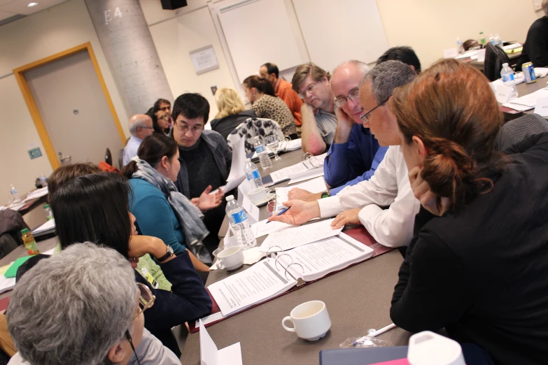 many people sitting in a meeting room