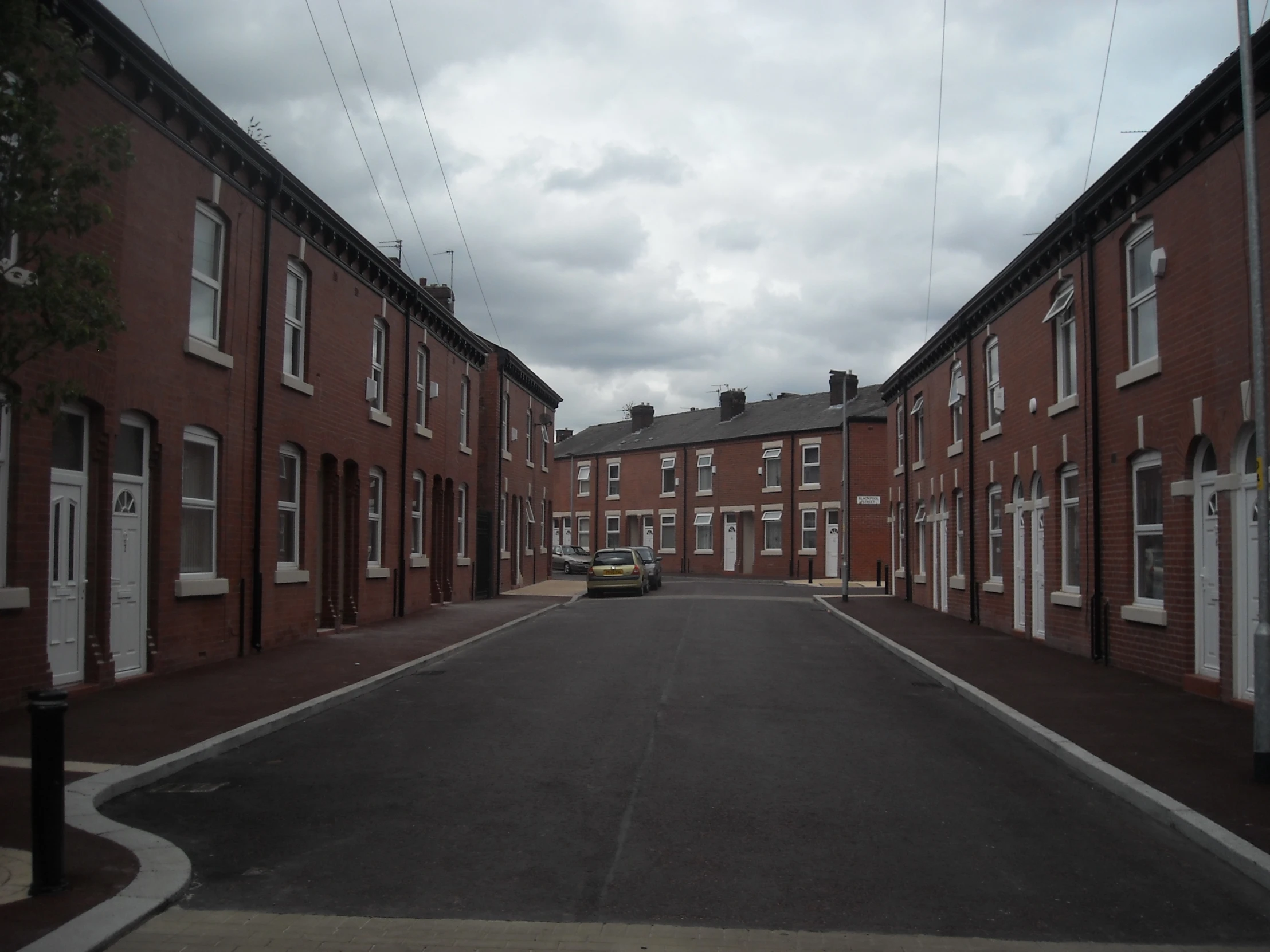 the empty road in front of the brick buildings