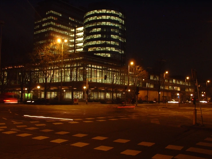 a large glass building in the center of a city