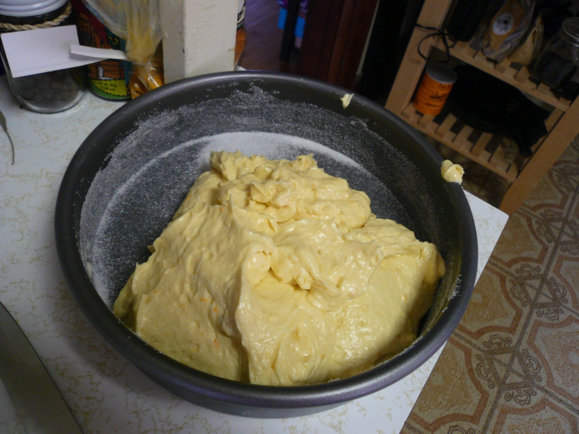 a bowl full of yellow batter on top of a counter