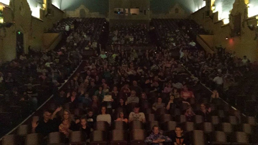 a bunch of people at an event with one sitting