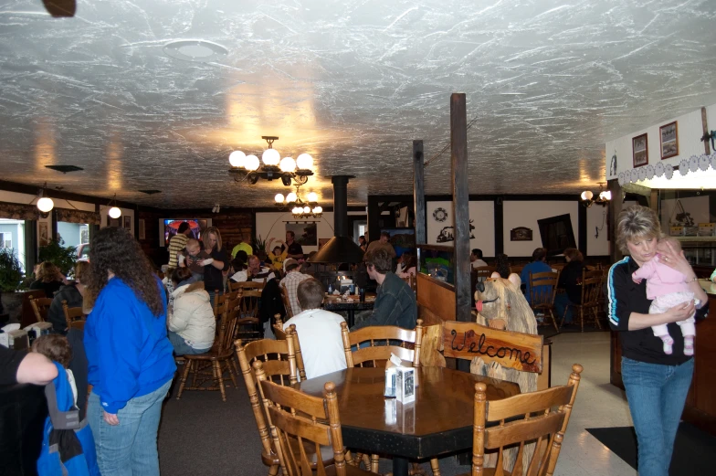 a group of people are gathered at tables