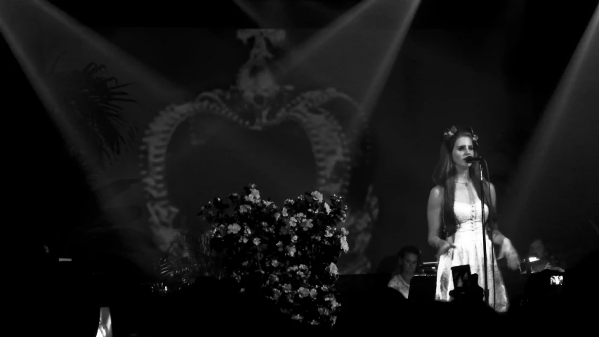 a woman in a white dress on stage