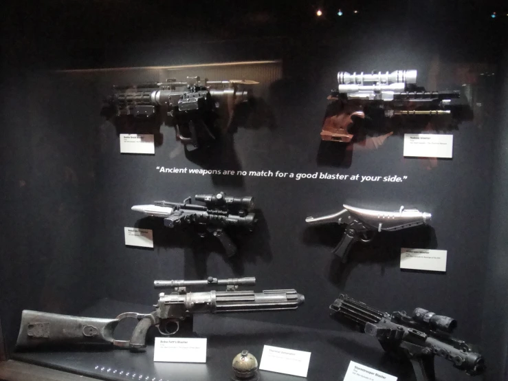 two guns are shown sitting on display near a few other guns