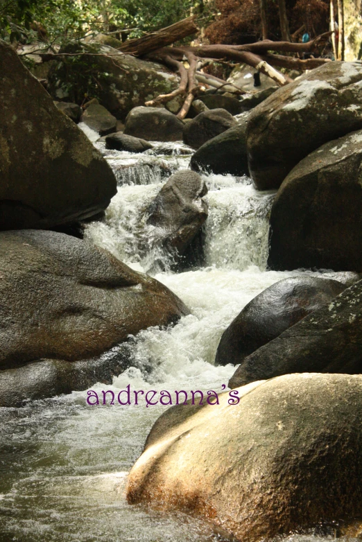 a close up of water flowing over rocks with words underneath