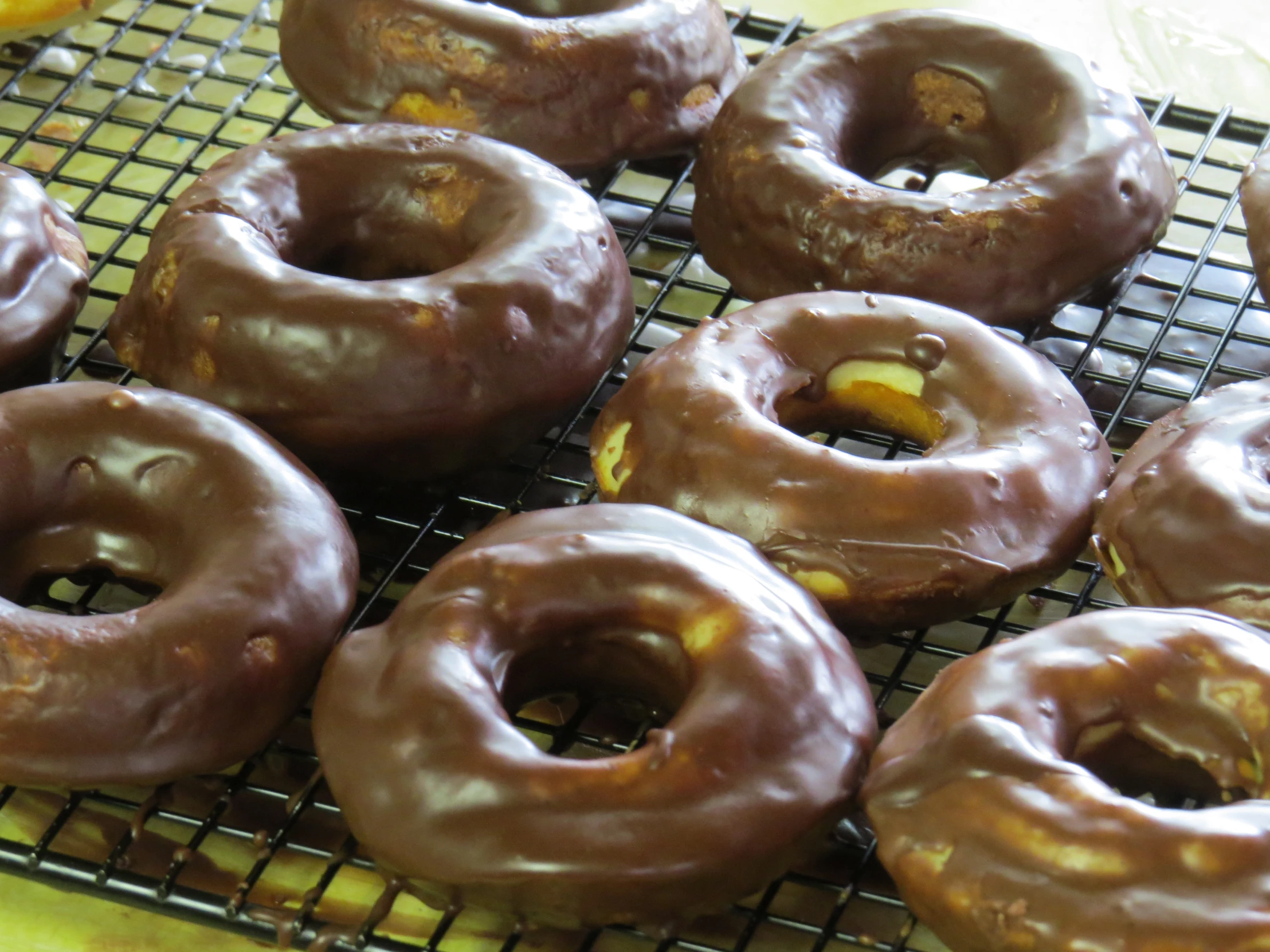 eight glazed doughnuts sitting on top of a cooling rack