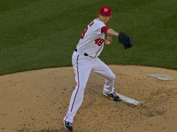 a baseball pitcher throwing a pitch during a game