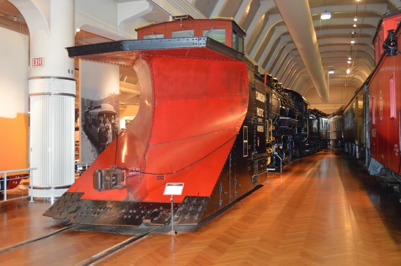 red train in the middle of a large room