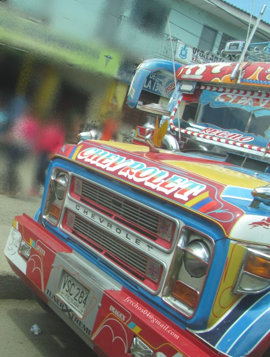 a bright colored truck with food painted on the front