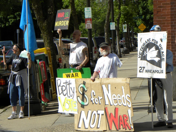 some men with some signs on the side walk