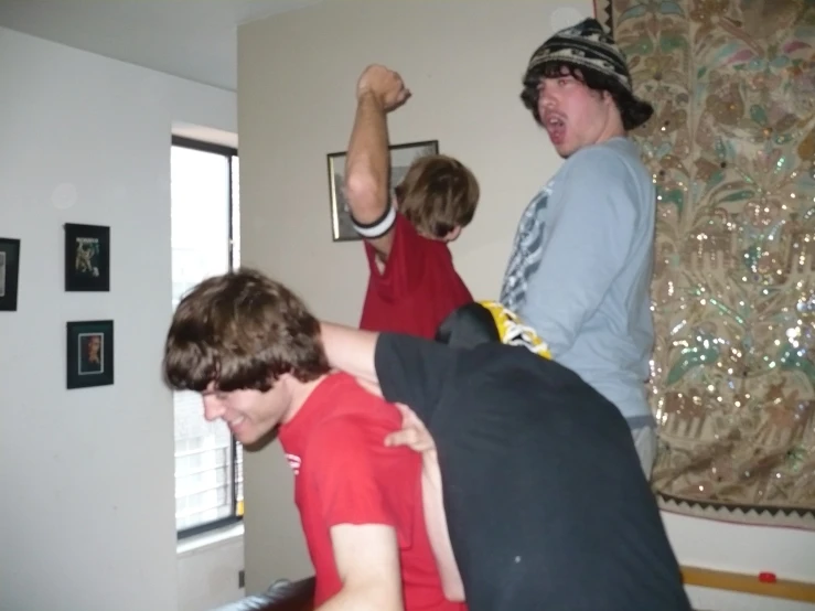 four people stand around in the living room together