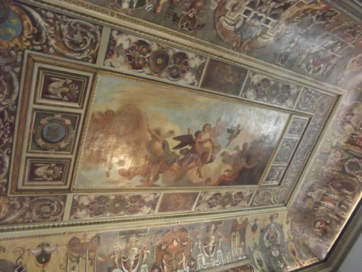 an elaborate ceiling with paintings and gold