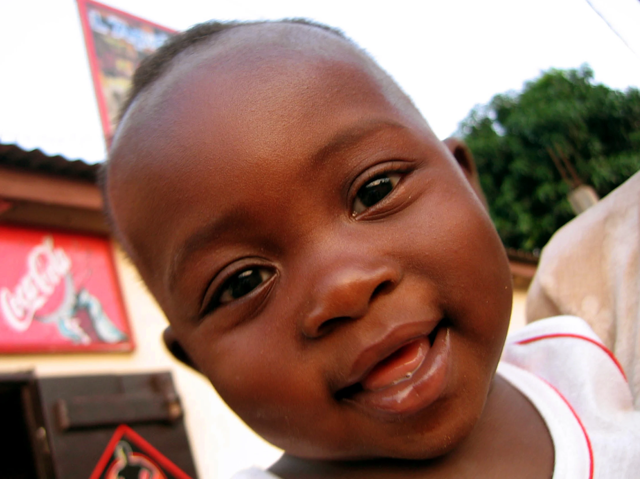 a young black baby is smiling for the camera