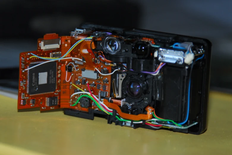 a camera with wires running from the rear of it