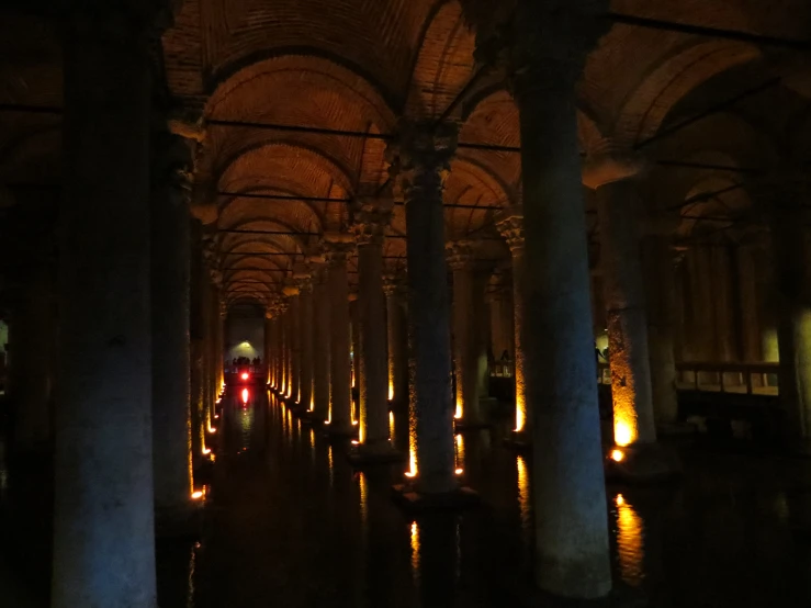 a long row of pillars with lights in between them