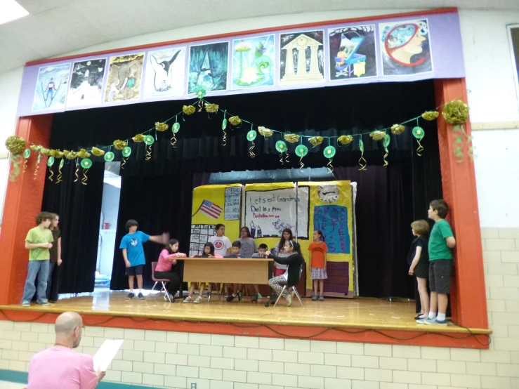 a group of children on stage singing at a performance