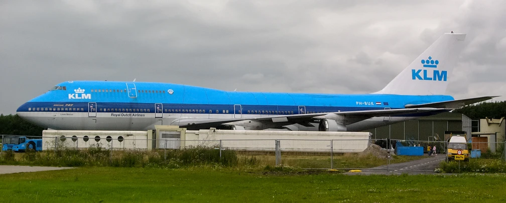 a big airplane that is blue and white on some grass