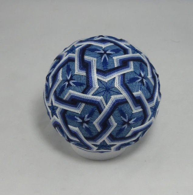 a small blue bowl with geometric designs