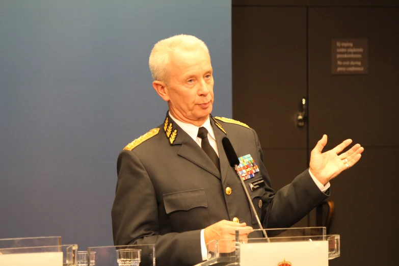 military man in uniform making speech at podium