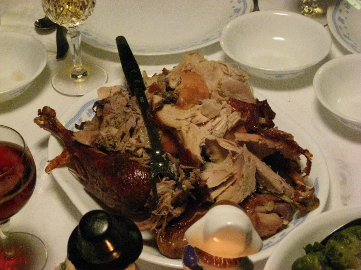 a large meat dinner on a white table