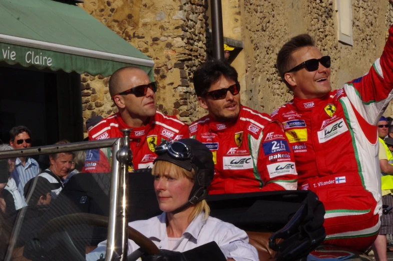 three men with different uniforms sitting next to each other