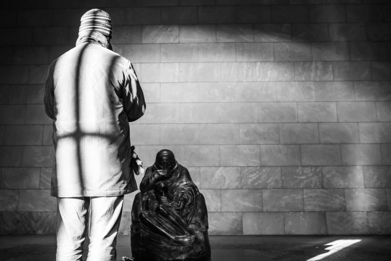 a person standing near a bag on the ground