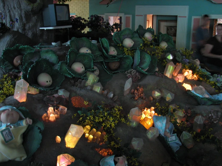 lighted candles and small statues in a yard