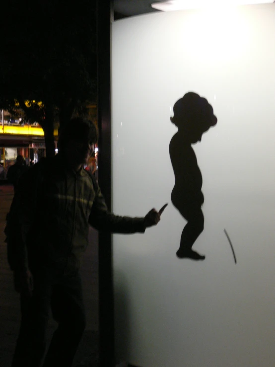 the shadow of a child has been cast onto the wall