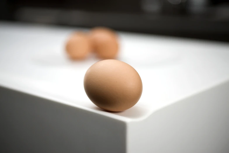 a single egg sitting on top of a white table