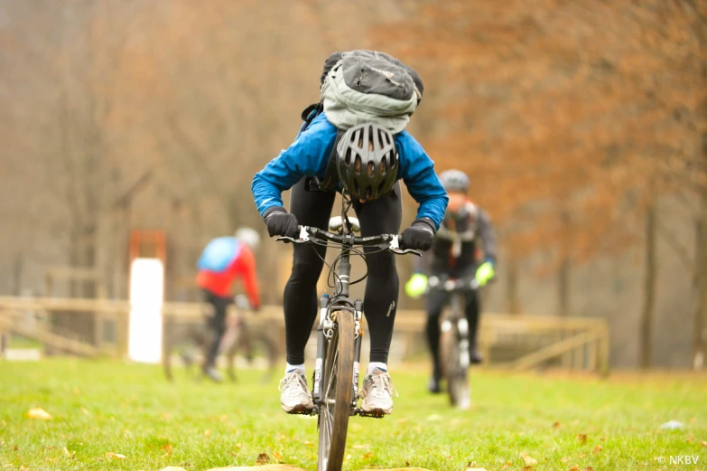 a person with a scarf and hat riding a bike