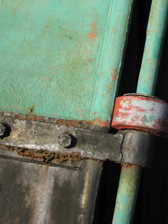 an old green wall with rust and rivets